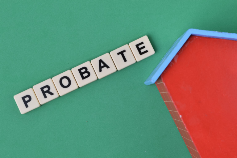 Letter tiles spelling Probate next to a small model house
