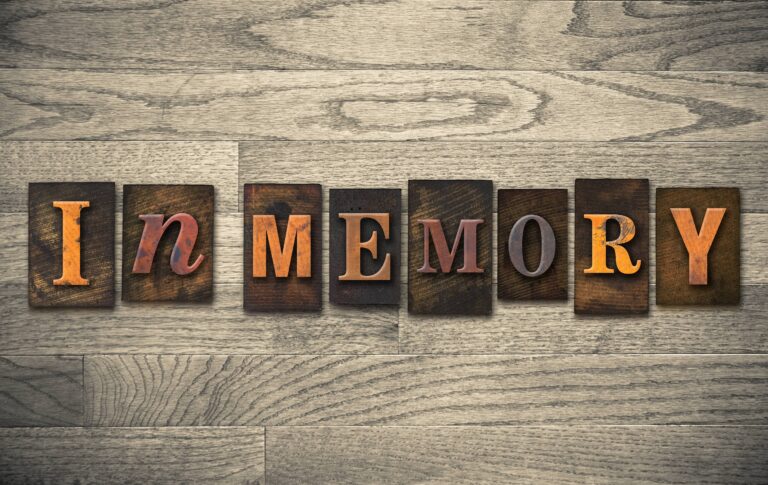 Wooden letterpress blocks spelling In Memory on a wood surface